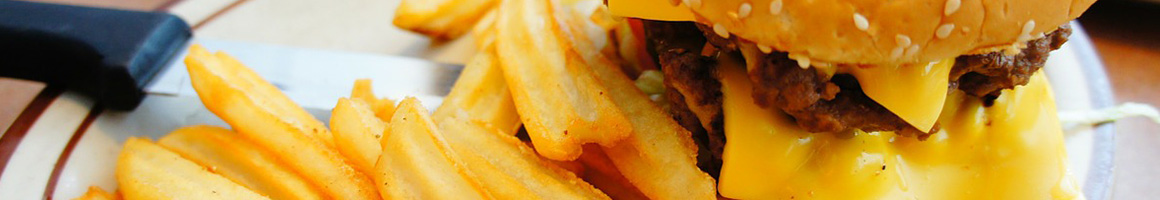 Eating American (Traditional) Burger Sandwich at Huey's Poplar restaurant in Memphis, TN.